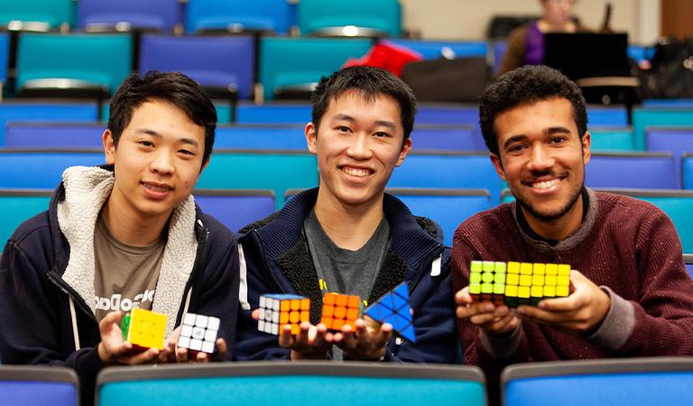 Harvey Mudd students holding up rubics cubes.