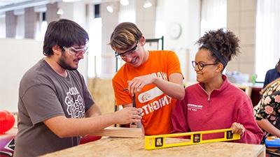 Students working together on a wooden project.